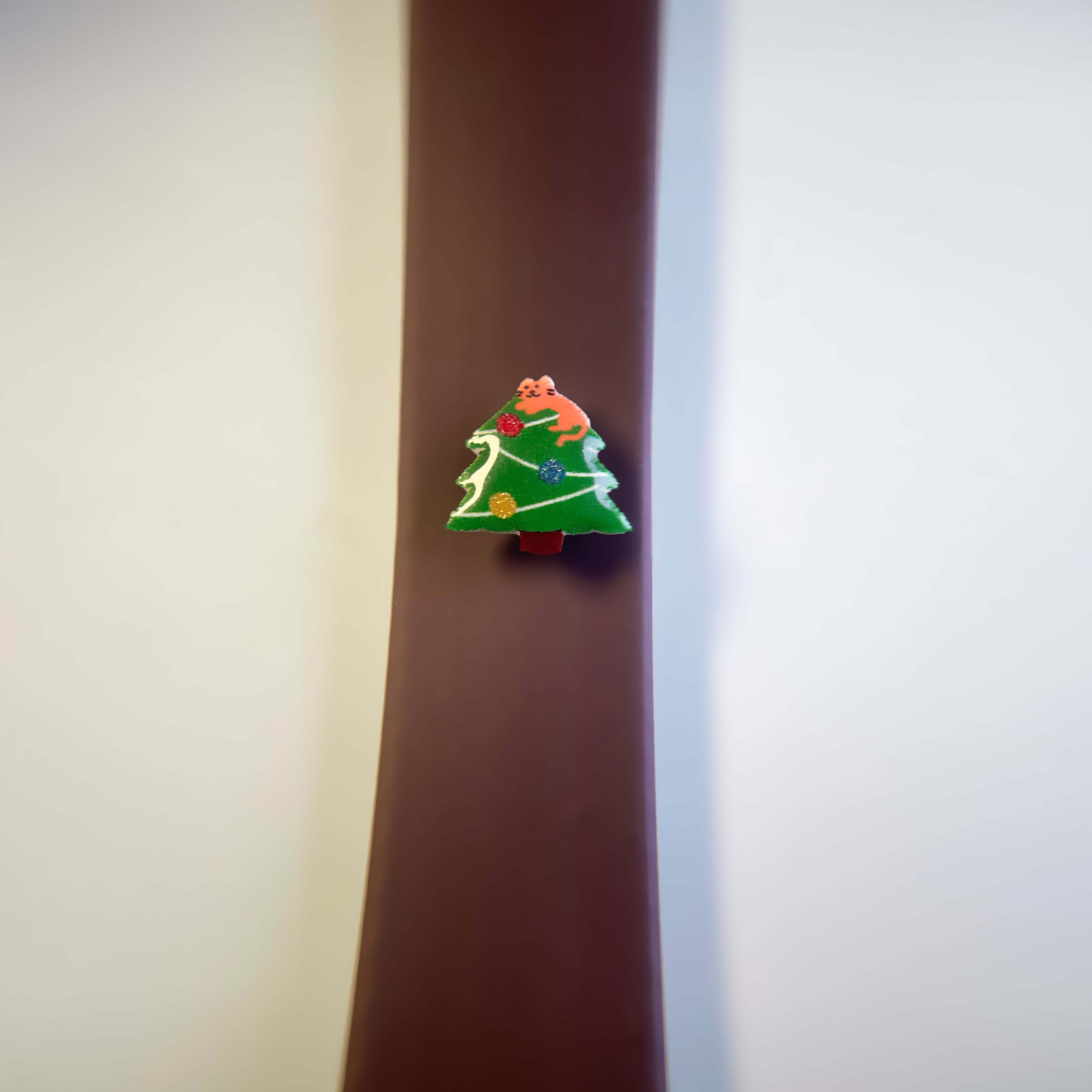 Brown dog leash with a Christmas tree enamel charm.