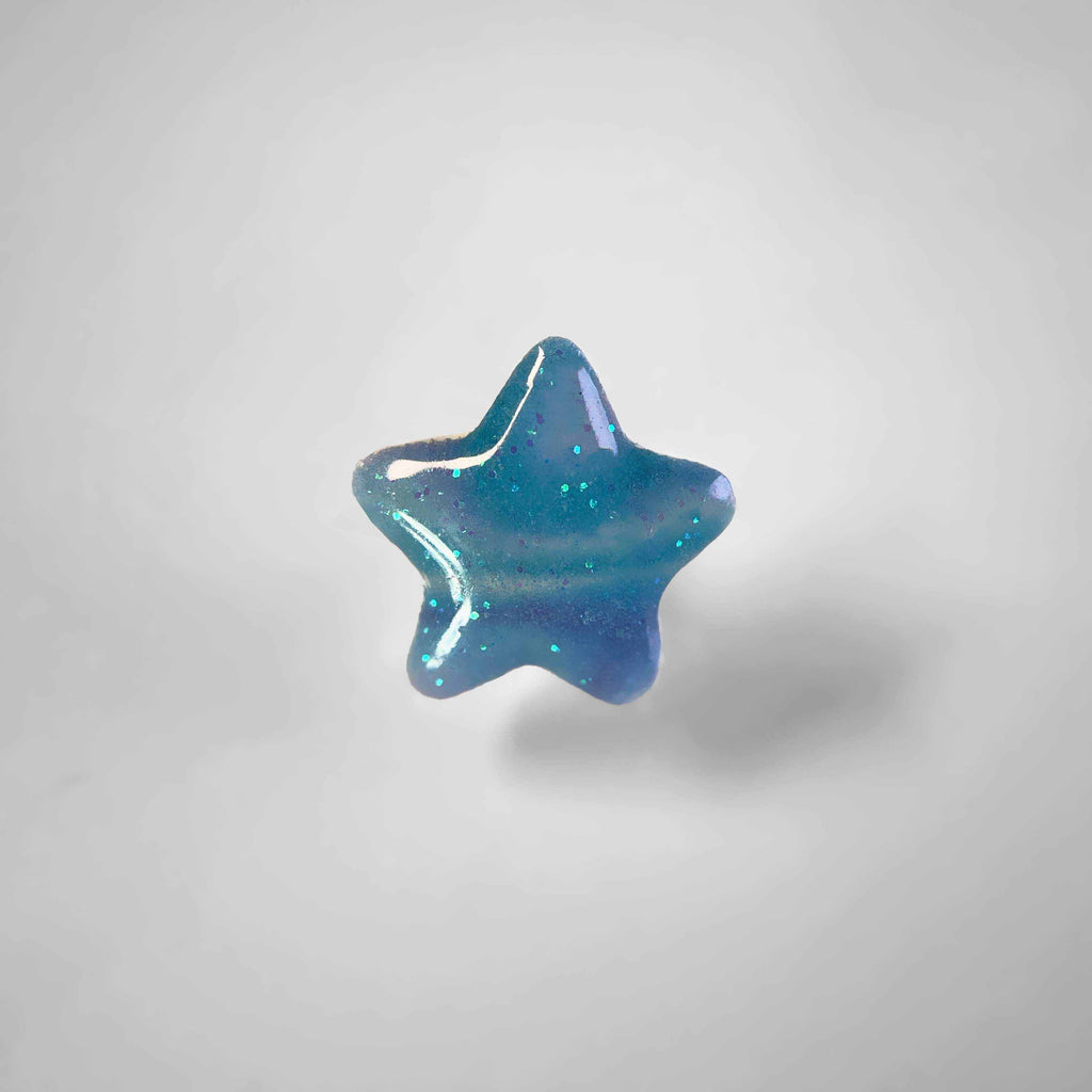 Dog collar charm shaped like a blue star.