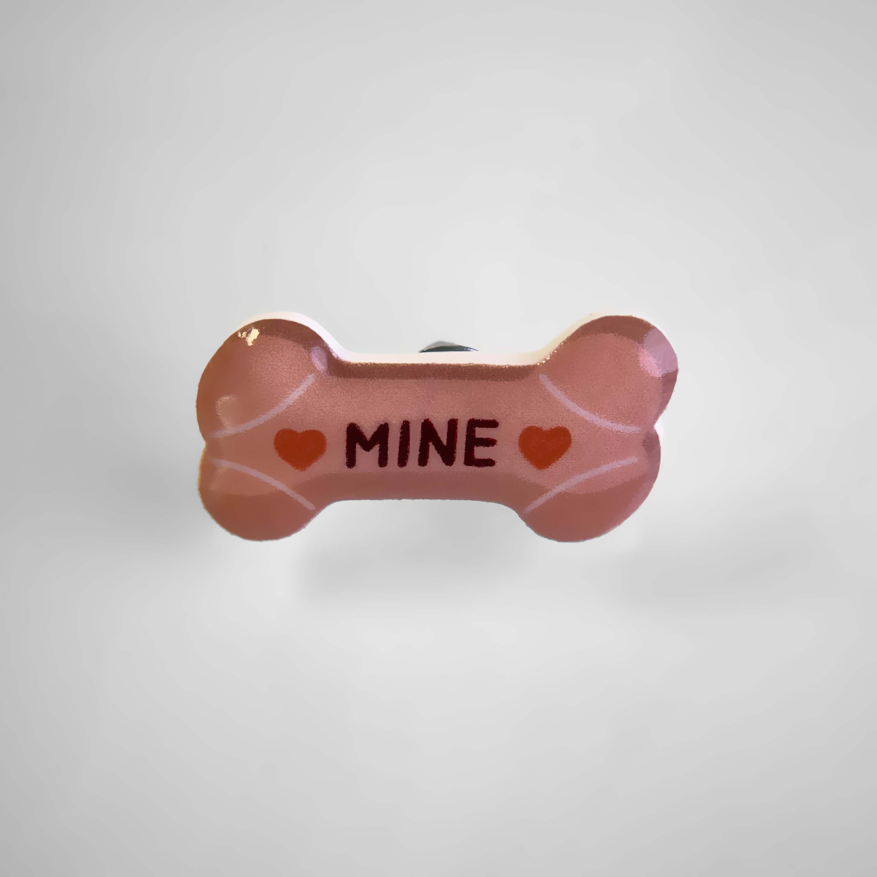 Dog collar charm shaped like a milk bone with the word 'Mine.'