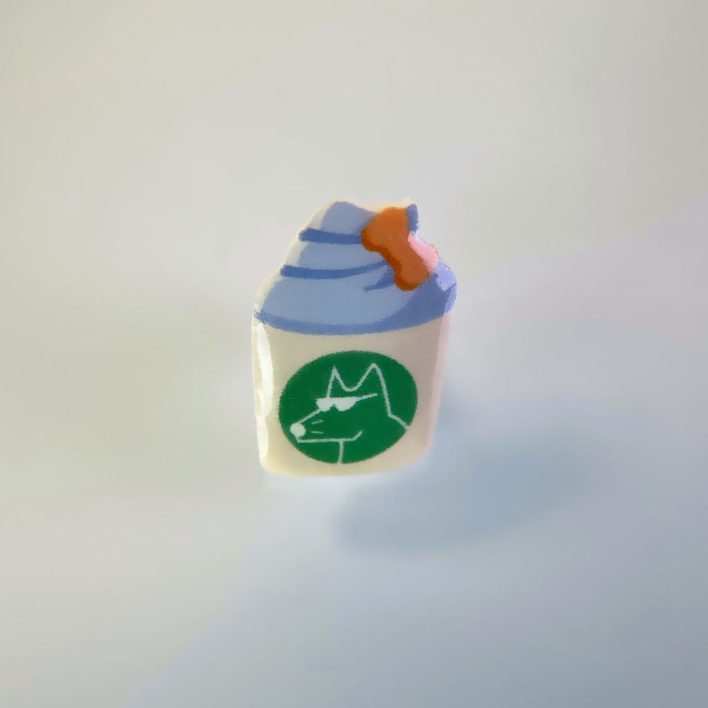 Dog collar charm shaped like a puppuccino with a milk bone in the whipping cream