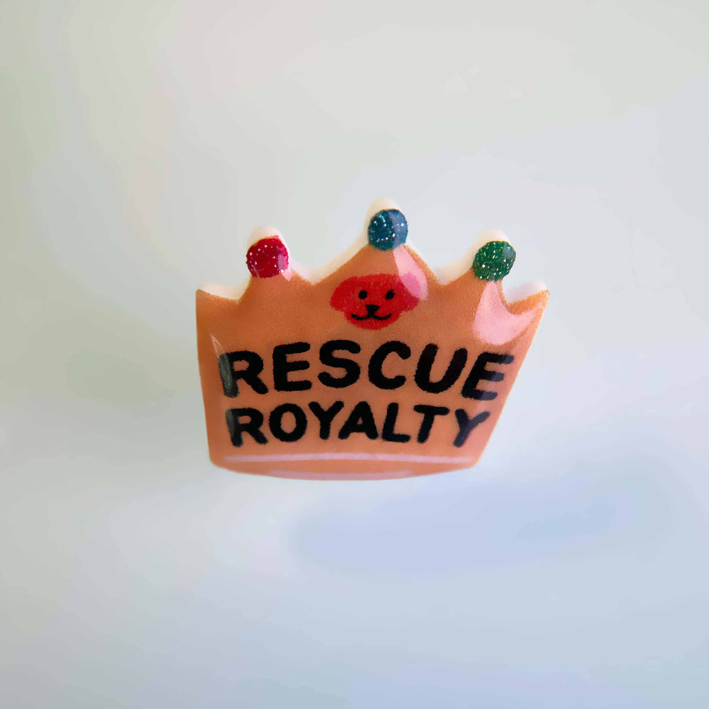 Dog collar charm shaped like a crown with words 'Rescue Royalty'.