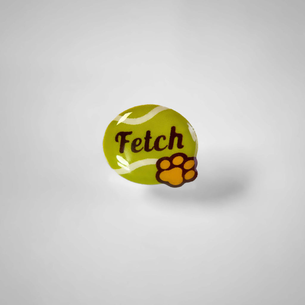 Dog collar charm shaped like tennis ball with words 'Fetch'